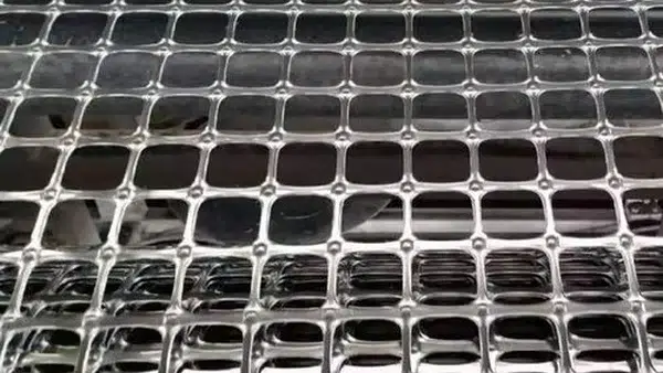 Biaxial geogrid aperture detail for aggregate interlock in road base stabilization
