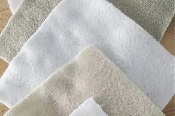 Layered nonwoven geotextile samples for comparing drainage fabric requirements