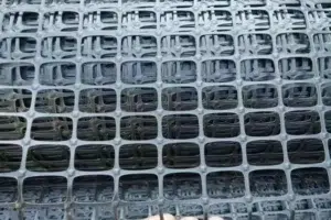 Biaxial geogrid material for pavement base stabilization and aggregate confinement