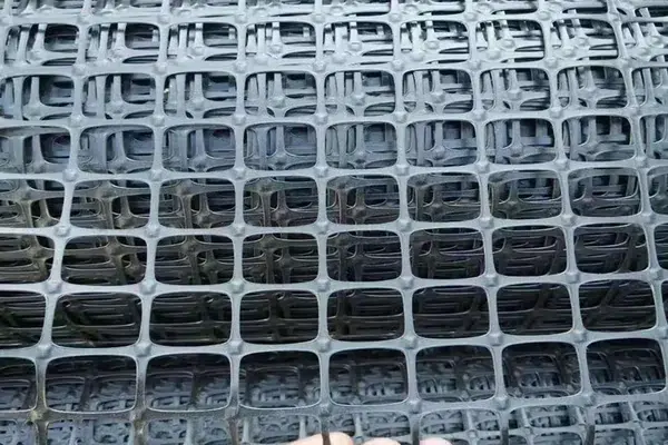Biaxial geogrid material for pavement base stabilization and aggregate confinement