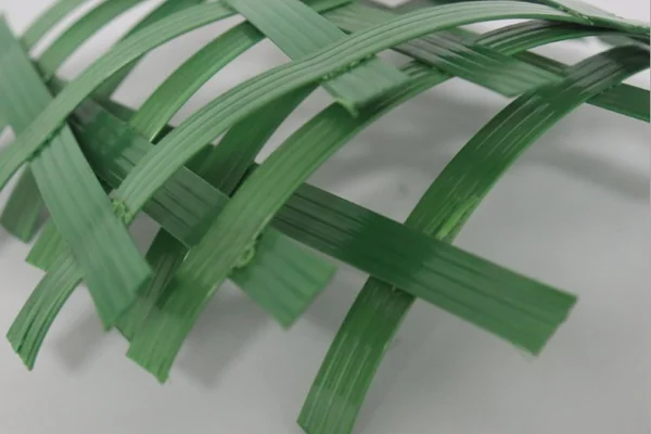 Polyester geogrid aperture detail for aggregate interlock and reinforcement checks