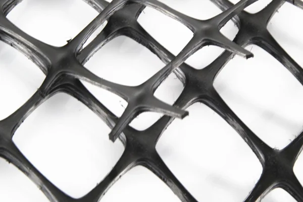 Open geogrid apertures used to review aggregate interlock and road-base stabilization