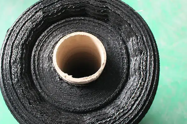 Close view of woven geotextile fabric for strength and opening-size discussion