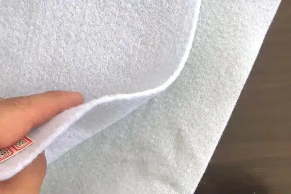 Geotextile layer for drainage aggregate wrap