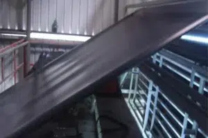 Black geomembrane sheet moving through a production line