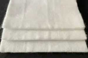 White nonwoven geotextile folded in several layers