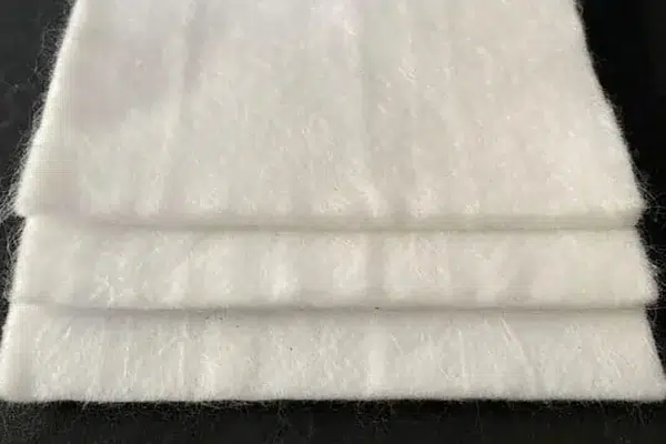 White nonwoven geotextile folded in several layers